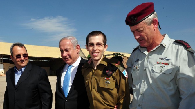 Released Israeli soldier Gilad Shalit walks with Israeli Prime Minister Benjamin Netanyahu, Defense Minister Ehud Barak, and Israeli Chief of Staff Lt. Gen. Benny Gantz, at the Tel Nof Air base in southern Israel, Tuesday, Oct. 18, 2011. Photo by Ariel Hermoni, Defense Ministry