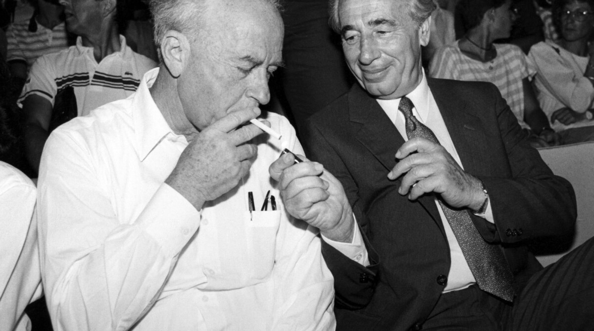 שמעון פרס מסייע ליצחק רבין להדליק סיגריה, 1986 (צילום: משה שי)
