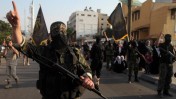 איש גדודי עז א-דין אל-קסאם של החמאס במצעד צבאי לציון יום השנה למבצע "עמוד ענן", עזה, 14.11.13 (צילום: עמד נאסר)
