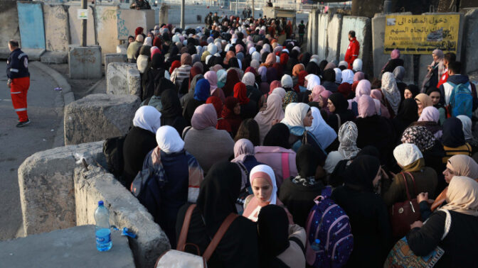 Palestinians make their way through the Israeli Qalandia checkpoint to attend the third Friday prayer of the holy fasting month of Ramadan in Jerusalem's Al-Aqsa mosque, near the West Bank city of Ramallah on April 22, 2022. Photo by Flash90