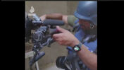 עיתונאי בוחן את המצלמה שניזוקה (צילום מסך מערוץ "אל-ג'זירה")