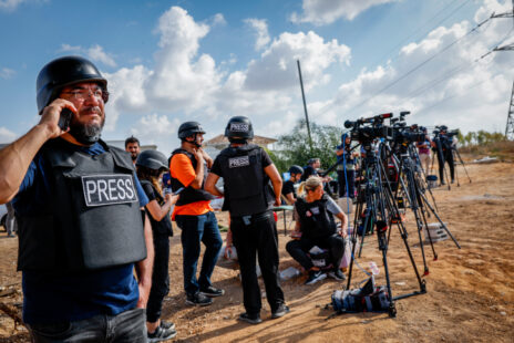 Foreign and Israeli journalists stand on a hill overlooking the Gaza Strip in the city of Sderot, southern Israel, October 19, 2023. Photo by Nati Shohat/Flash90